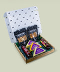 Gift box with snacks and cheeses on a light beige background