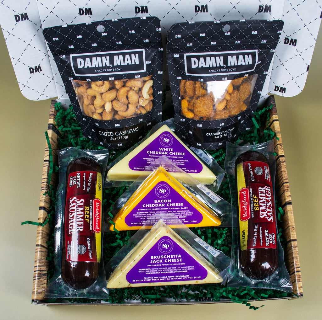 Damn Man Gourmet gift basket with snacks and cheese in a decorative box.
