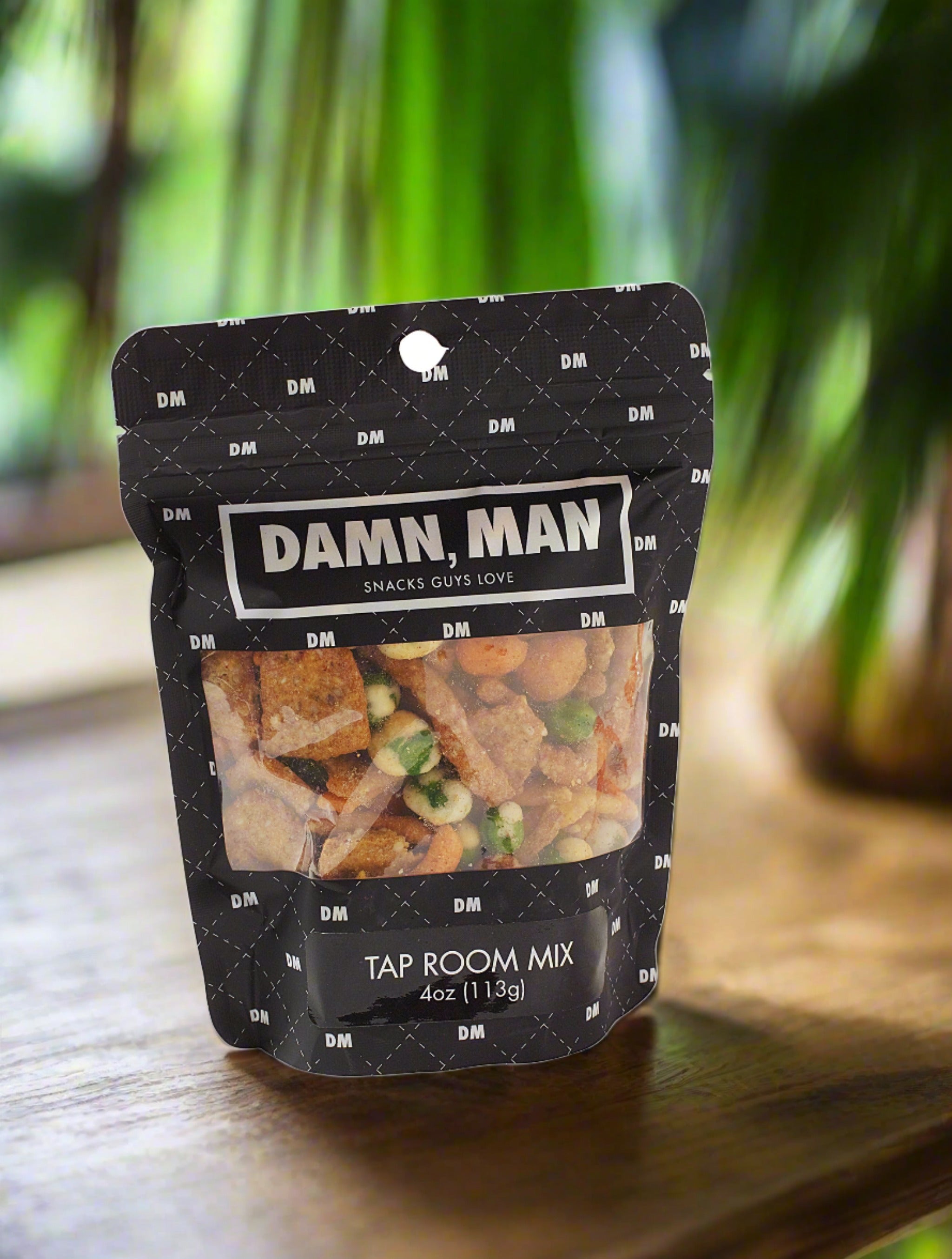 Damn, Man Tap Room Mix gourmet nuts in black packaging on wooden surface