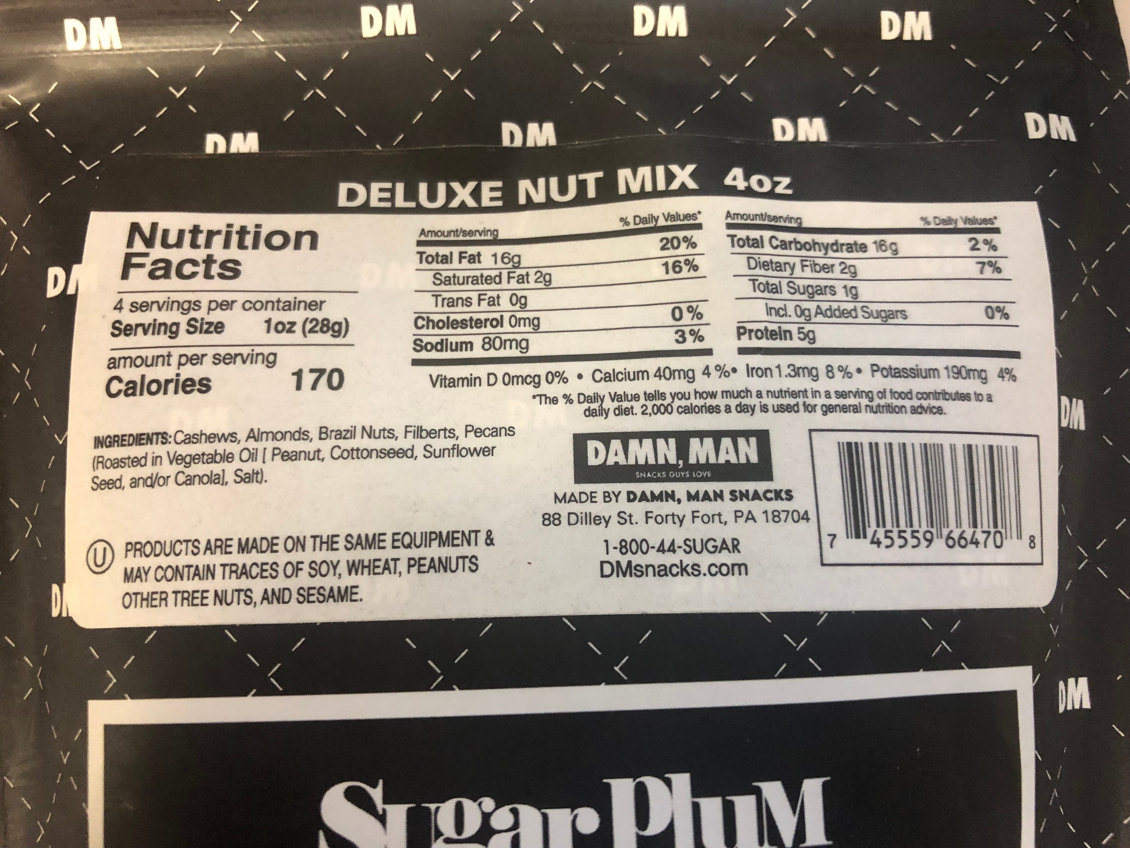Nutrition facts label of Damn, Man Deluxe Nut Mix 4 oz package showing calories, ingredients, and other nutritional information.