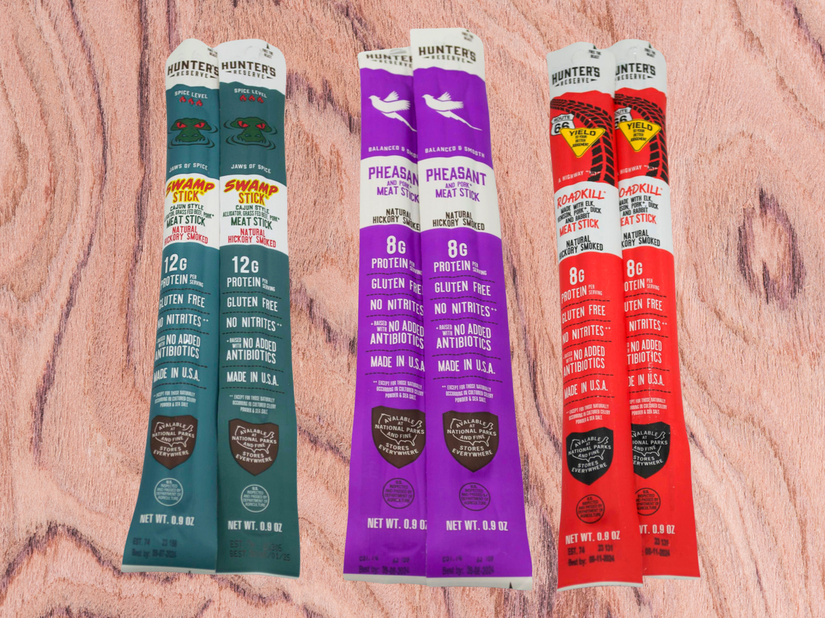 Exotic Meat Sticks Bag with 14 wild-flavored beef jerky snacks on a wooden background