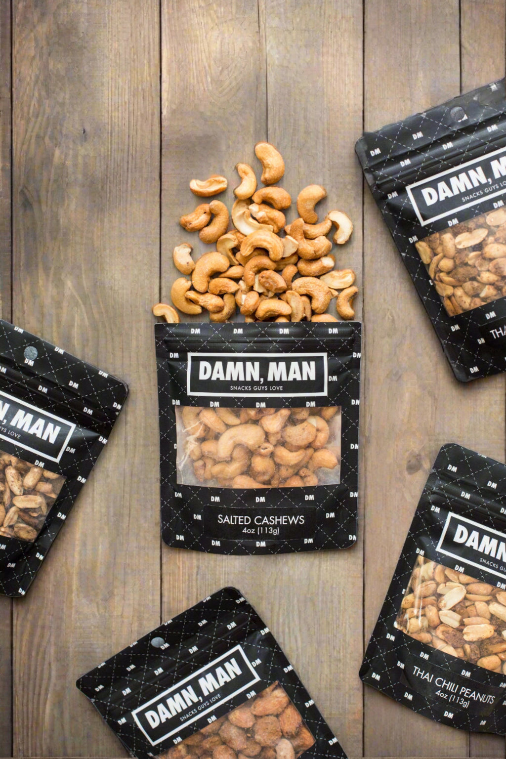 Assorted Damn, Man salted cashews and mixed nuts on rustic wooden surface