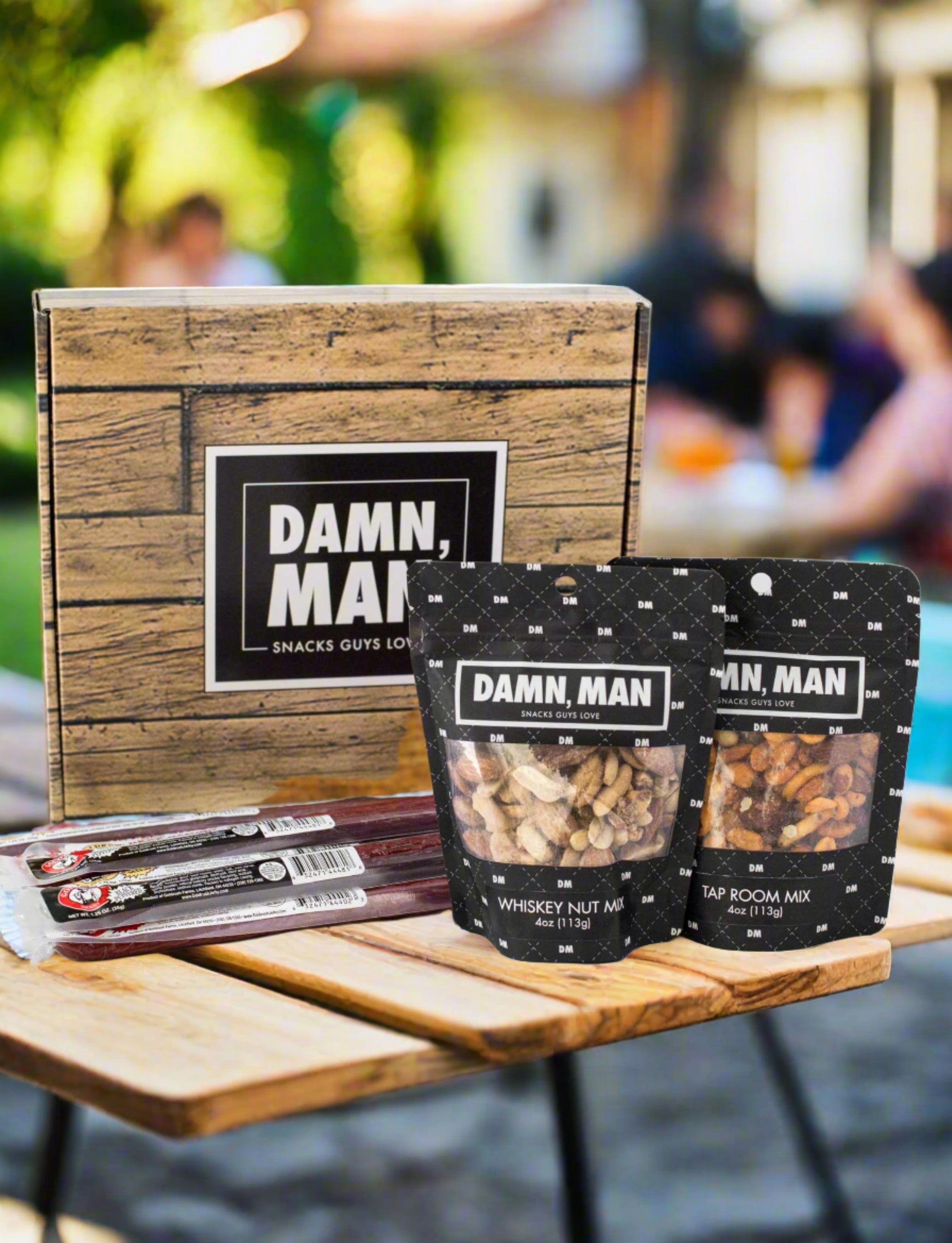 Nuts & Beef Box with whiskey nut mix, tap room mix, and beef sticks displayed on a table